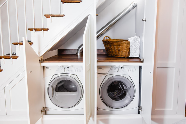 Compact laundry room under stairs doors