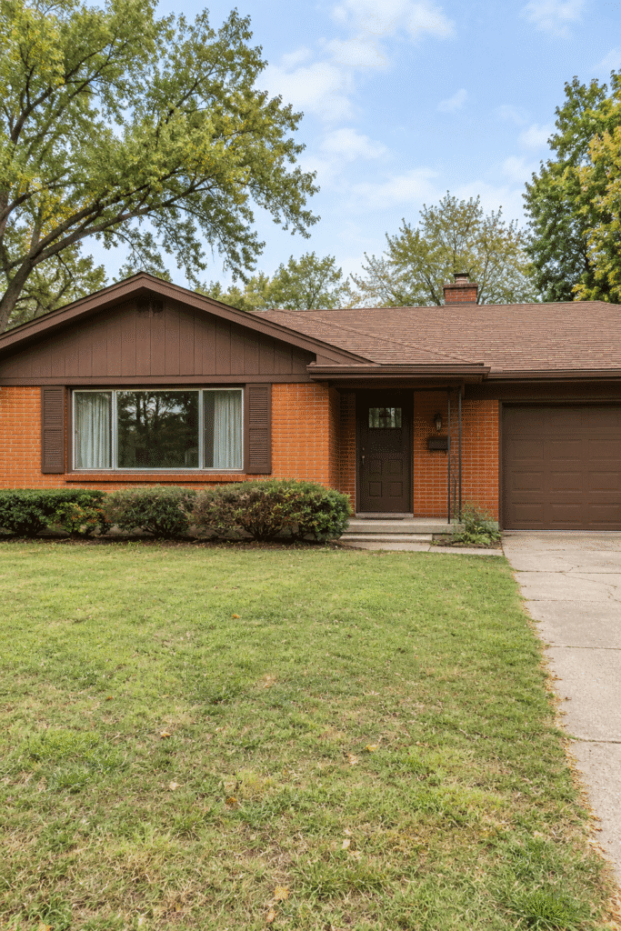 1960s ranch house with dated orange-red brick and brown trim before exterior update